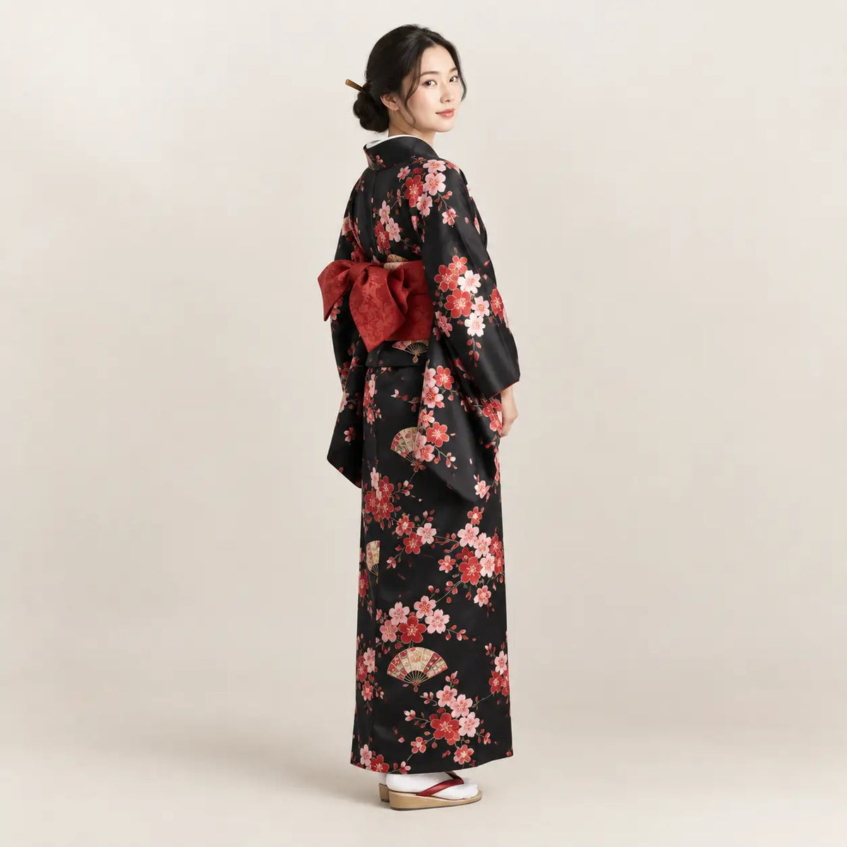 Black kimono with vibrant pink and red cherry blossom patterns and matching obi sash from japanese kimono collection Image