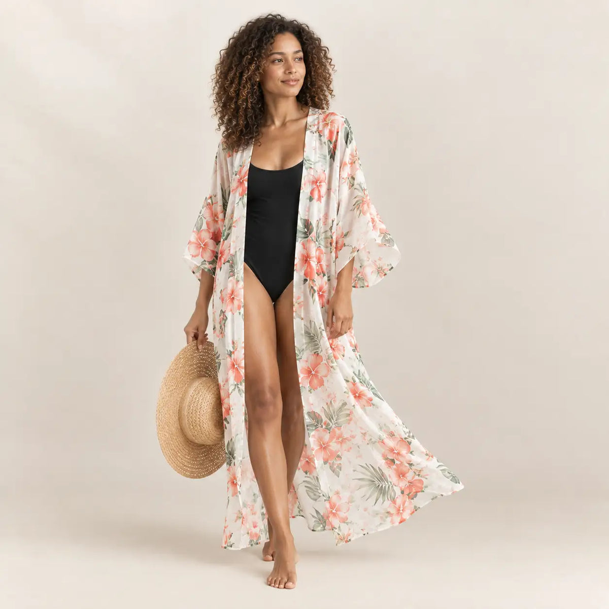 A flowing long-sleeved cream kimono cover up with vibrant coral and green tropical floral patterns for the beach Image