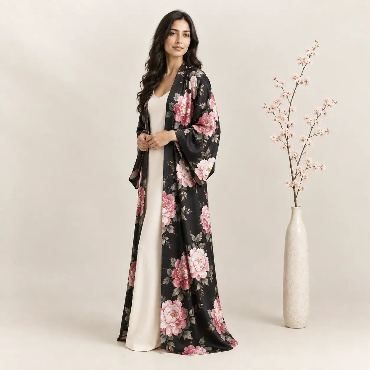 A flowing black long kimono made of lightweight silk fabric with vibrant pink and white floral patterns Image