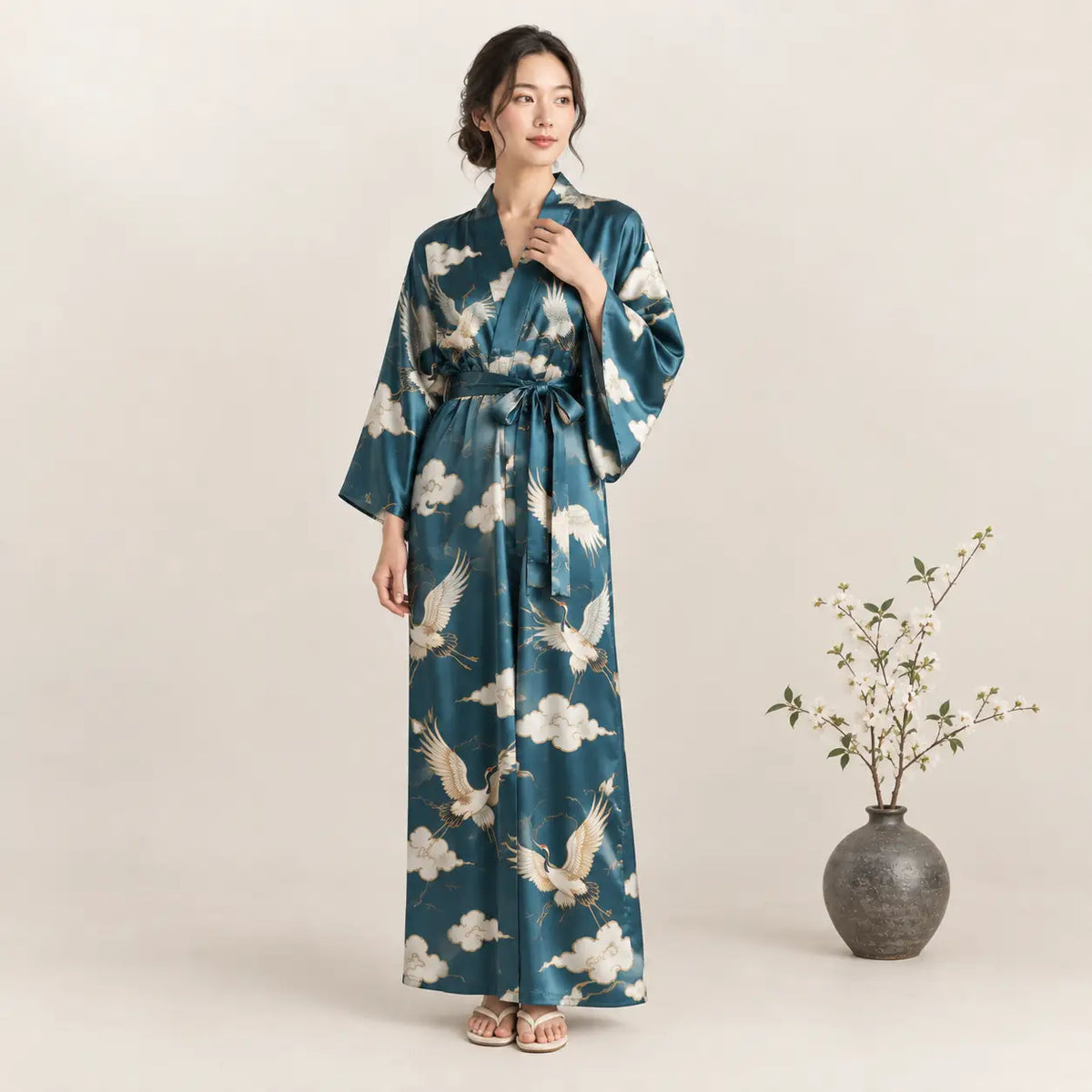 A teal silk kimono robe with white crane and cloud patterns wide sleeves and matching belt from Silk Kimono collection Image