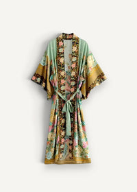 A flowing light mint-green beach kimono cardigan with intricate floral and bird patterns and a matching tie belt