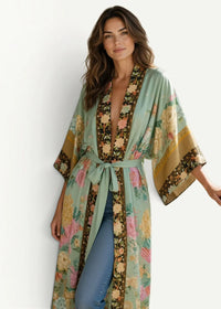 A flowing mint green beach kimono cardigan with vibrant pink yellow and brown floral pattern