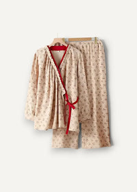 Beige cotton kimono pajamas with subtle floral pattern and red ribbon tie for comfortable loungewear