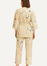 Beige women’s kimono pajamas in cream-colored fabric featuring playful panda and abstract dot patterns