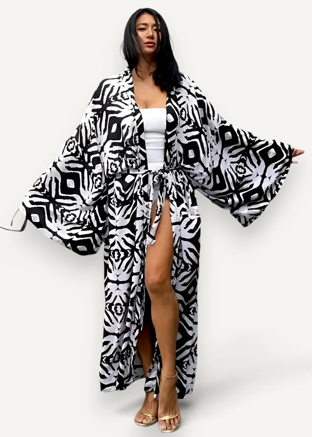 Black and white kimono-style robe with geometric pattern and wide sleeves shown from the back side