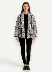 Black haori quilted jacket with black and white patterns and beige geometric accents