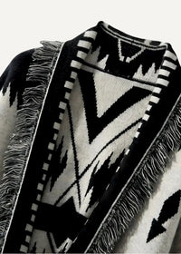 Black kimono jacket women’s with black and white geometric-patterned knit poncho and fringed edges shown from back
