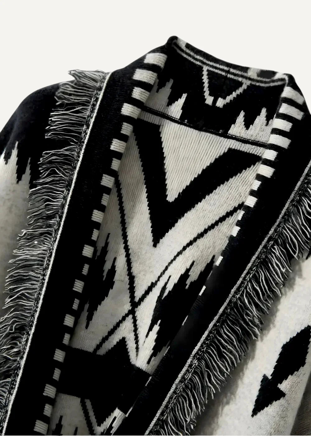 Black kimono jacket women’s with black and white geometric-patterned knit poncho and fringed edges shown from back