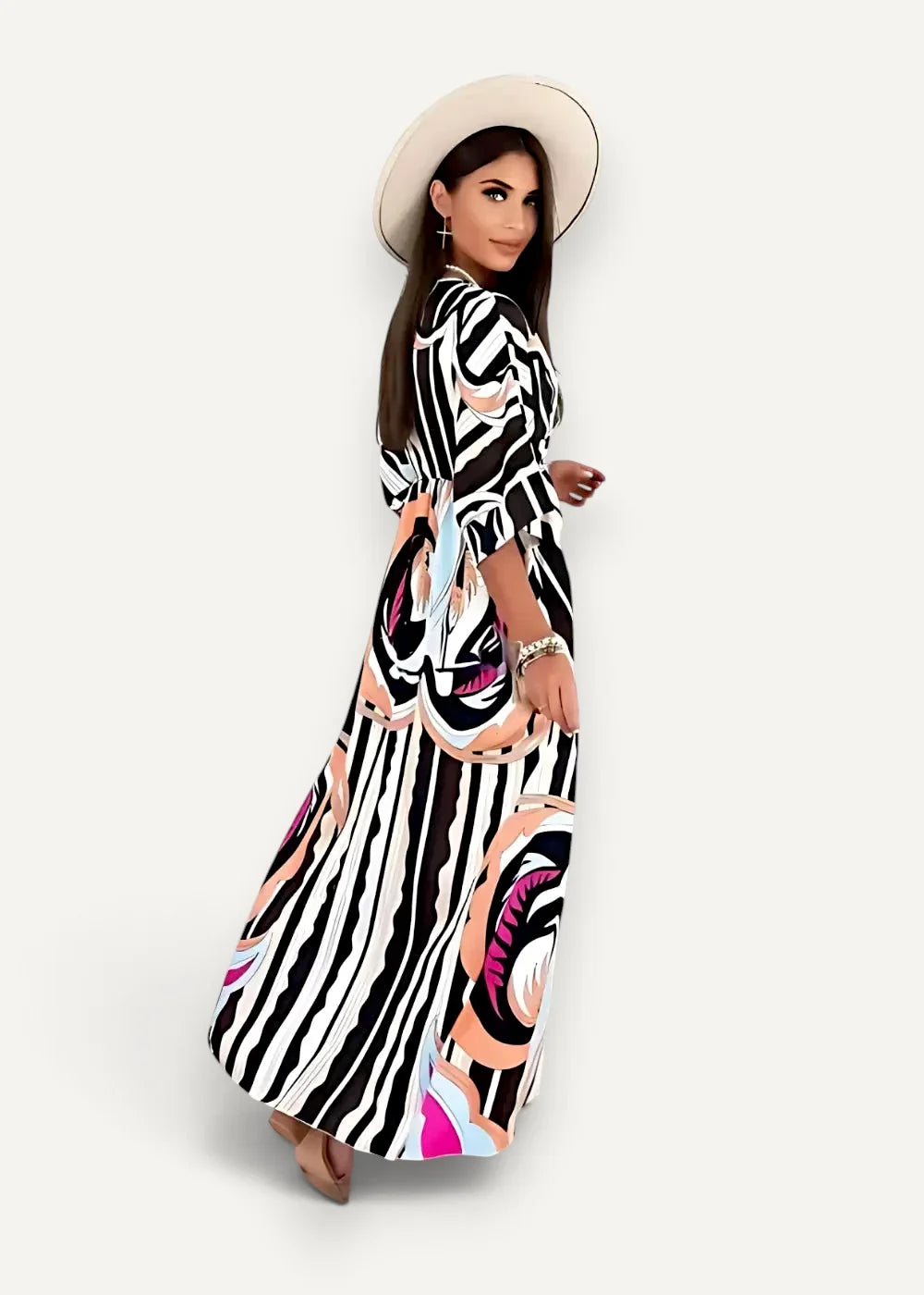 A woman wearing a black kimono maxi dress with bold black and white stripes and pink floral patterns