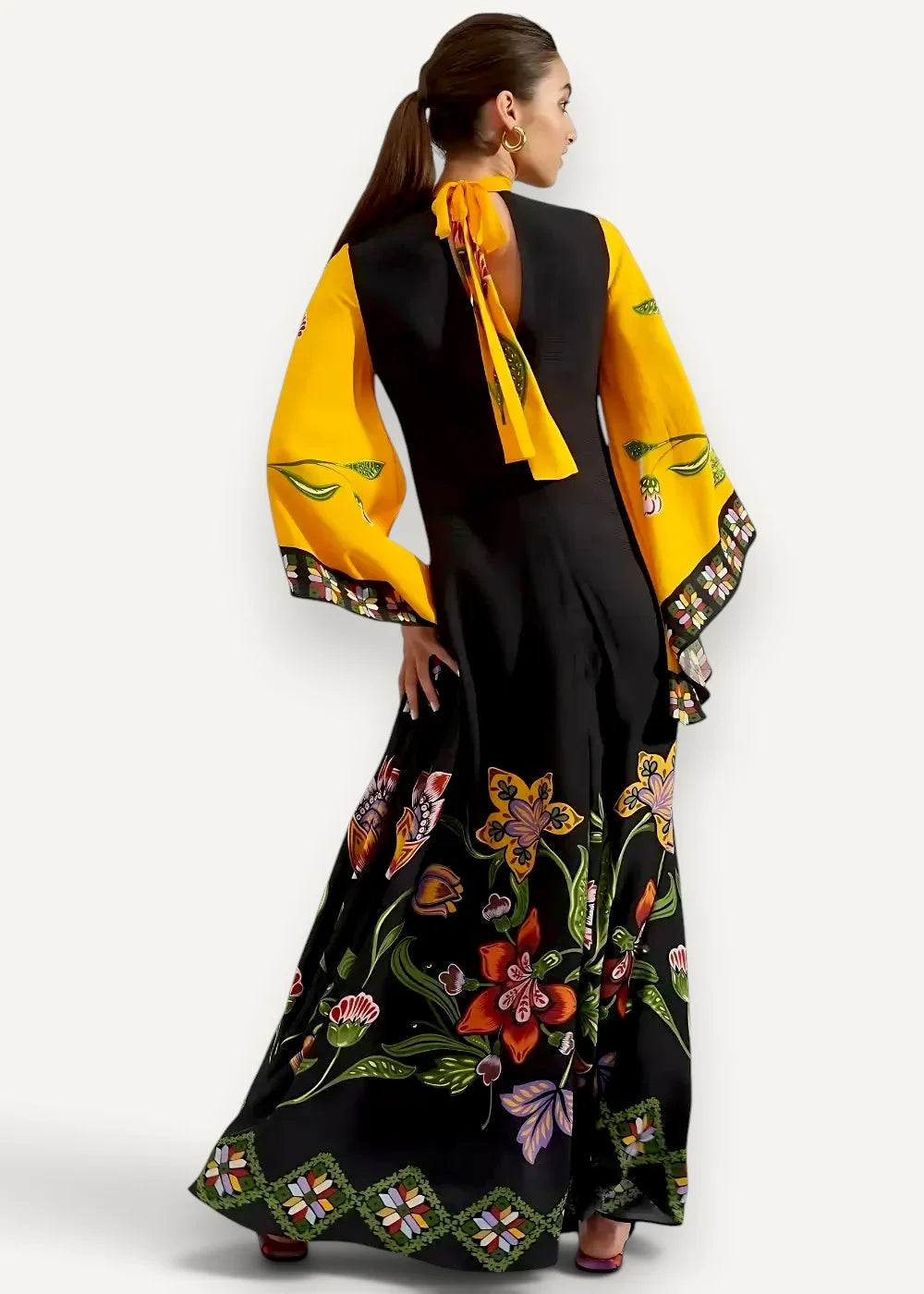 Black satin kimono dress with vibrant yellow bell sleeves and floral pattern in orange pink green and white