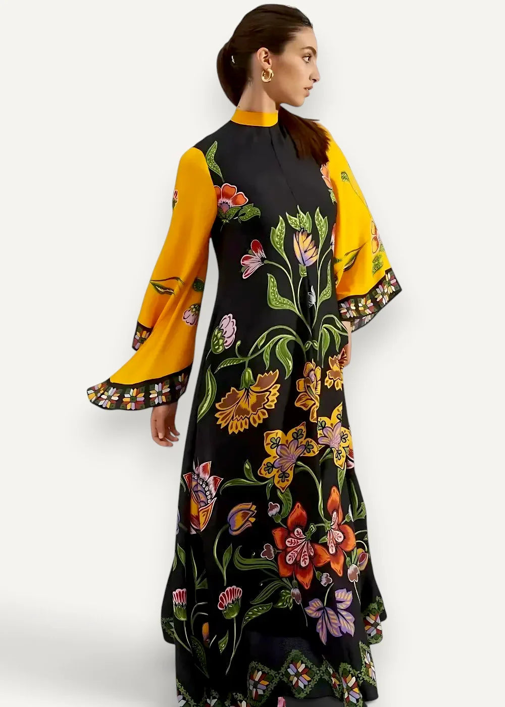 Black satin kimono dress with vibrant floral print, black base, yellow bell sleeves, and colorful blossoms