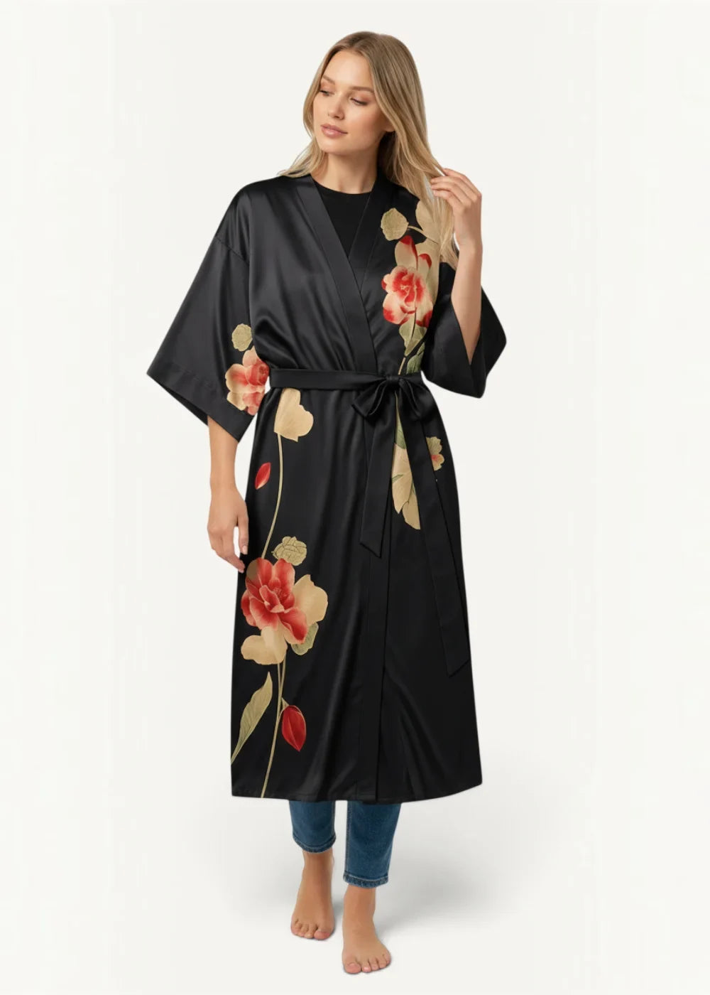 Black satin kimono robe with floral pattern featuring red and beige roses and green leaves tied at the waist