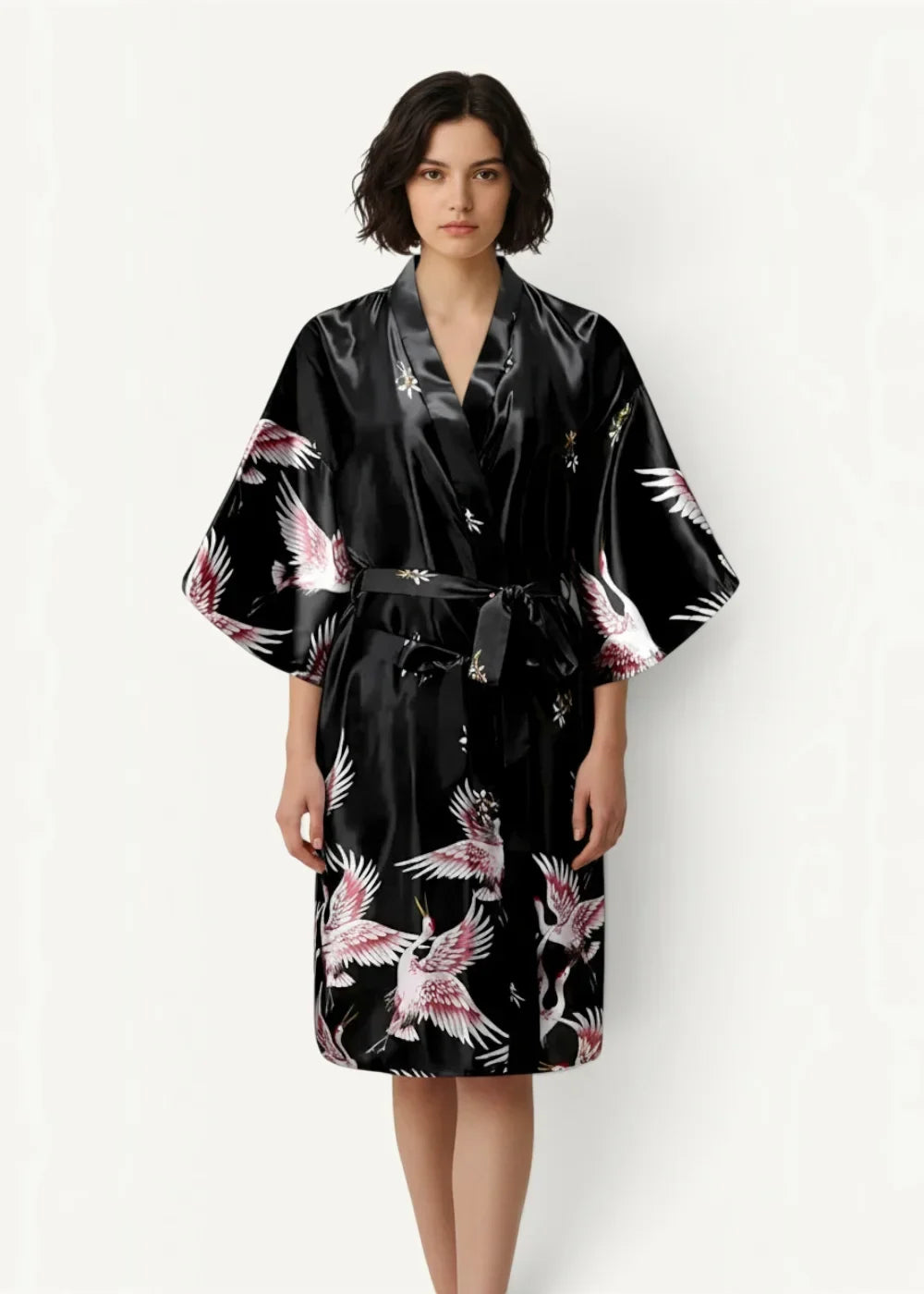 Black silk robe in satin fabric with vibrant pink and white cranes in flight pattern on front side