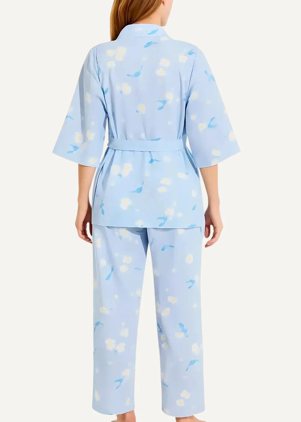 Light blue floral kimono pajamas featuring white and pale yellow blossoms with a relaxed top and wide-leg pants