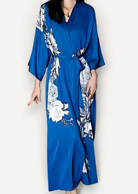 A flowing royal blue satin robe with elegant white and gray floral patterns along the sides and sleeves