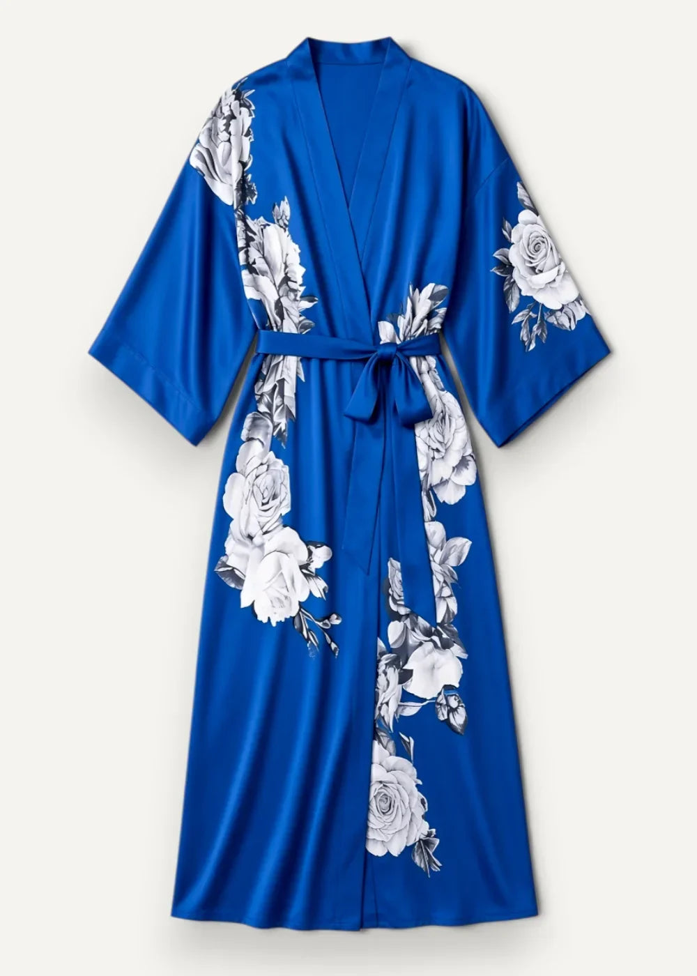 A vibrant royal blue satin robe with black and white rose floral pattern tied at the waist with matching belt