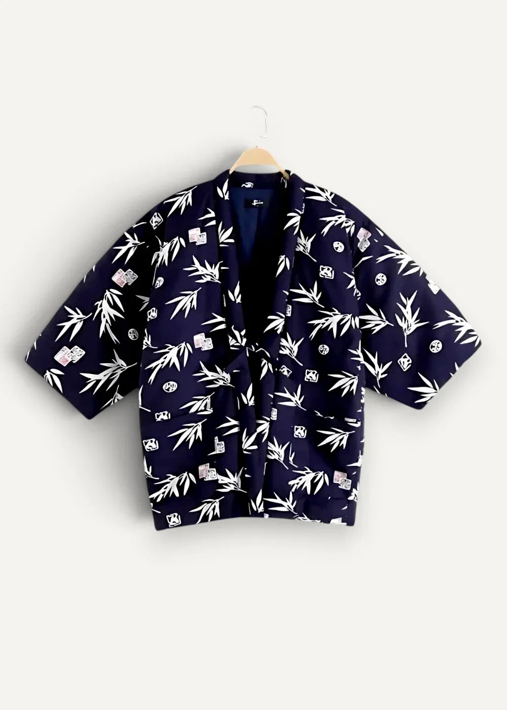 Dark blue kimono-style jacket by blue blue japan featuring white bamboo and dice patterns on fabric