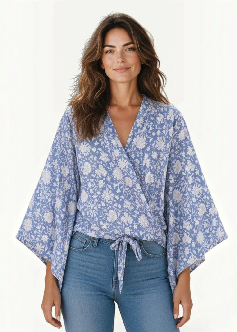 Blue kimono cardigan wrap blouse in light blue with white floral pattern and wide flowing sleeves tied at the waist