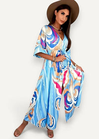 Blue kimono dress featuring a flowing vibrant blue maxi design with abstract pink white and gold swirl patterns