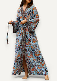 Blue kimono maxi dress with flowing light blue fabric, intricate orange and navy floral patterns, v-neckline, and wide sleeves