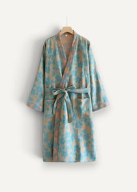 Light blue and beige floral boho kimono robe in cotton with a matching belt tied at the waist
