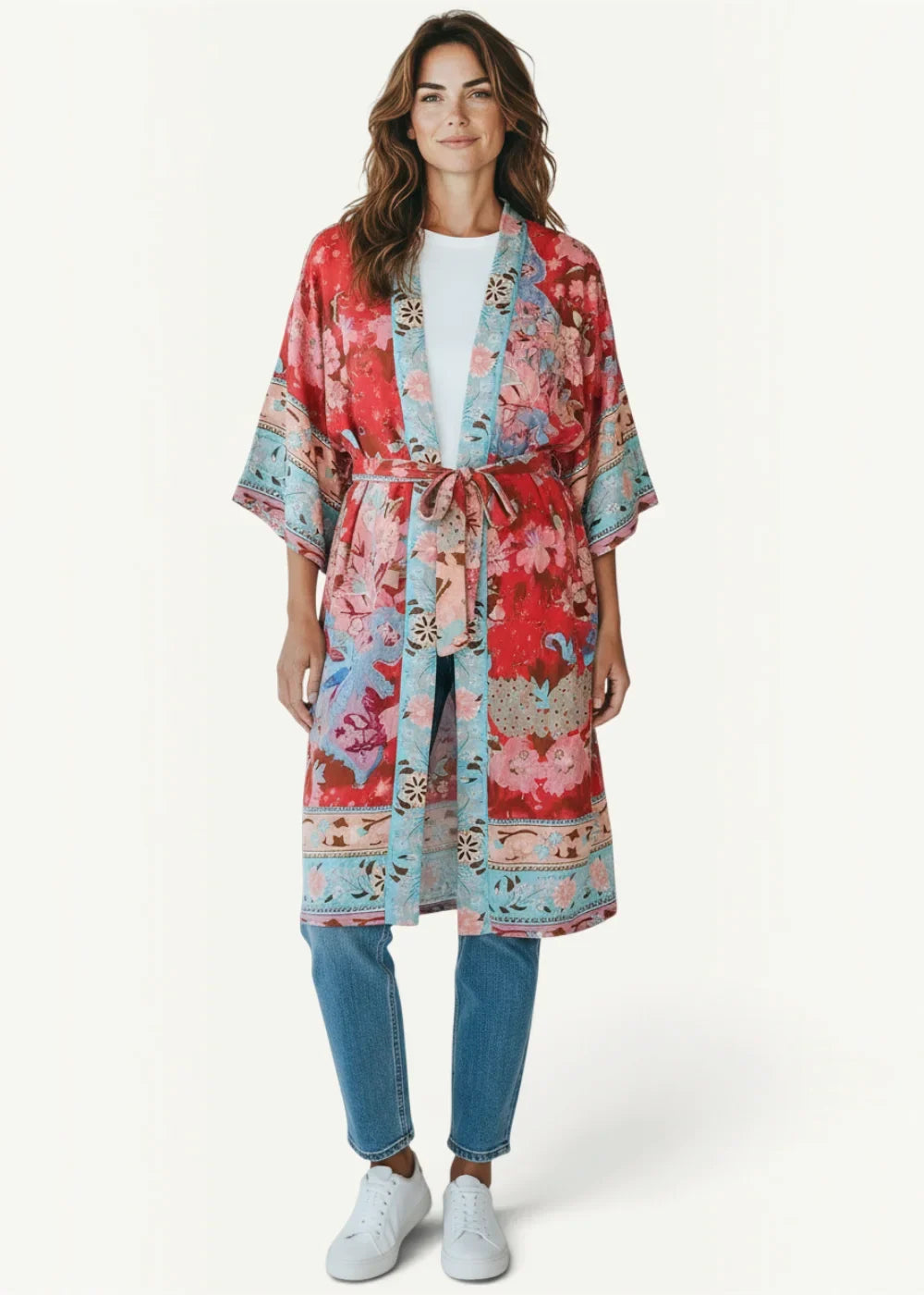 A boho style kimono with vibrant red and blue floral print made of lightweight fabric with a matching belt