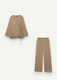 Beige wrap-front kimono blouse with wide sleeves and matching tapered trousers in soft fabric for stylish wear