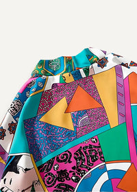 Casual haori vibrant patchwork blouse with bold geometric patterns and playful cartoon motifs in teal pink orange and purple