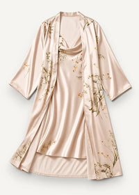 A blush pink satin robe with gold green floral pattern draped neckline and flowing three quarter sleeves from champagne nightgown set