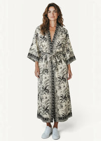 A flowing chiffon kimono dress with off-white and black floral pattern and a tie belt