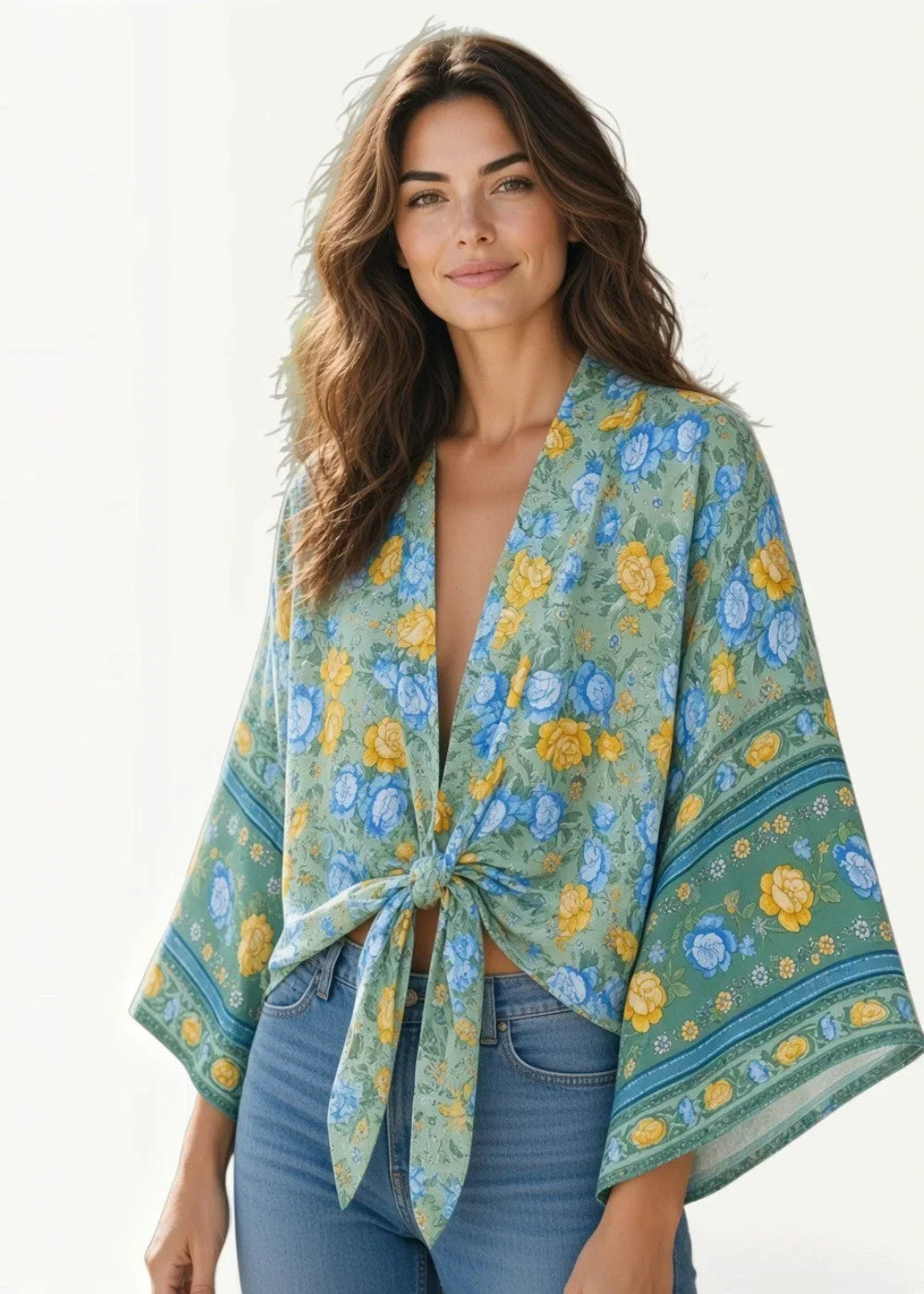 A light green cotton kimono cover up with yellow and blue blossoms tied at the front for a floral look