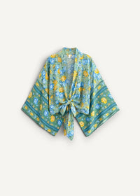 A flowing open-front cotton kimono cover up in vibrant green with yellow and blue floral patterns