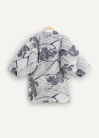 Cotton kimono jacket in white and navy blue with wave pattern and intricate black line detailing seen from the back