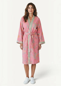 A soft pink cotton kimono robe with a subtle floral pattern light gray trim and a matching waist belt