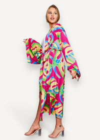 A vibrant cotton kimono with long sleeves and a bold abstract pattern in pink green yellow and blue hues
