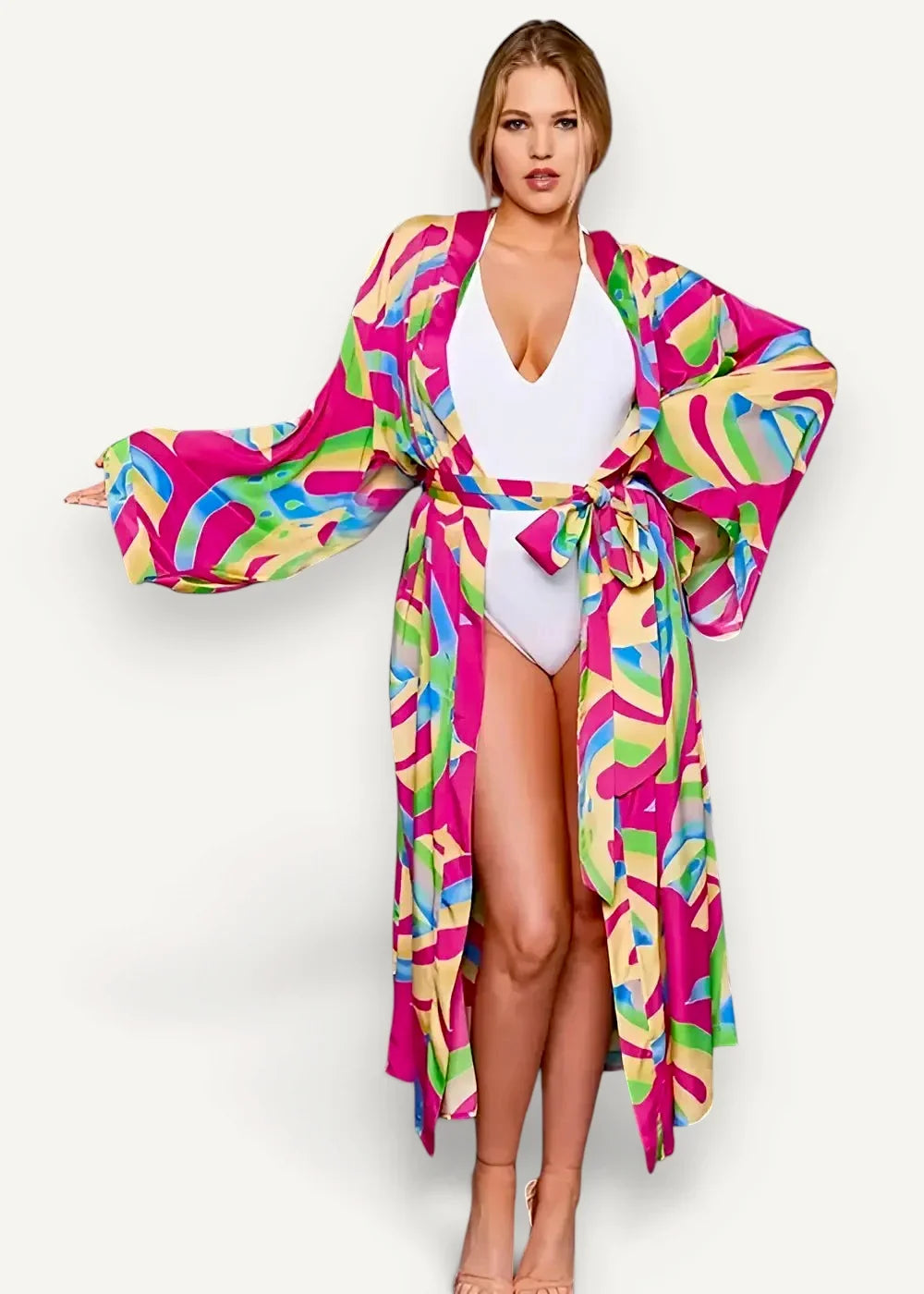 A vibrant cotton kimono with a bold abstract pattern in pink green blue and yellow hues and long sleeves