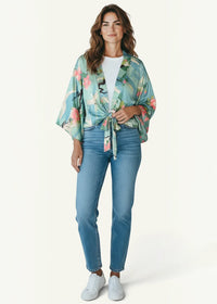 A light teal satin cropped kimono with a vibrant pink and green floral pattern tied at the waist