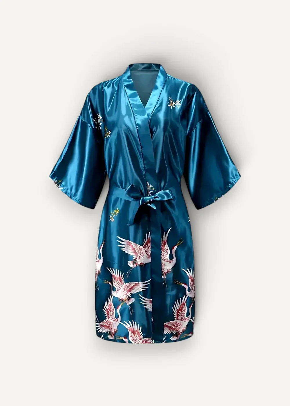 A teal satin silk dressing robe with a vibrant pink and white flying crane pattern tied at the waist with a matching belt
