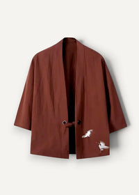 A rich rust-colored embroidered haori jacket with delicate white crane embroidery on the lower front and three-quarter sleeves