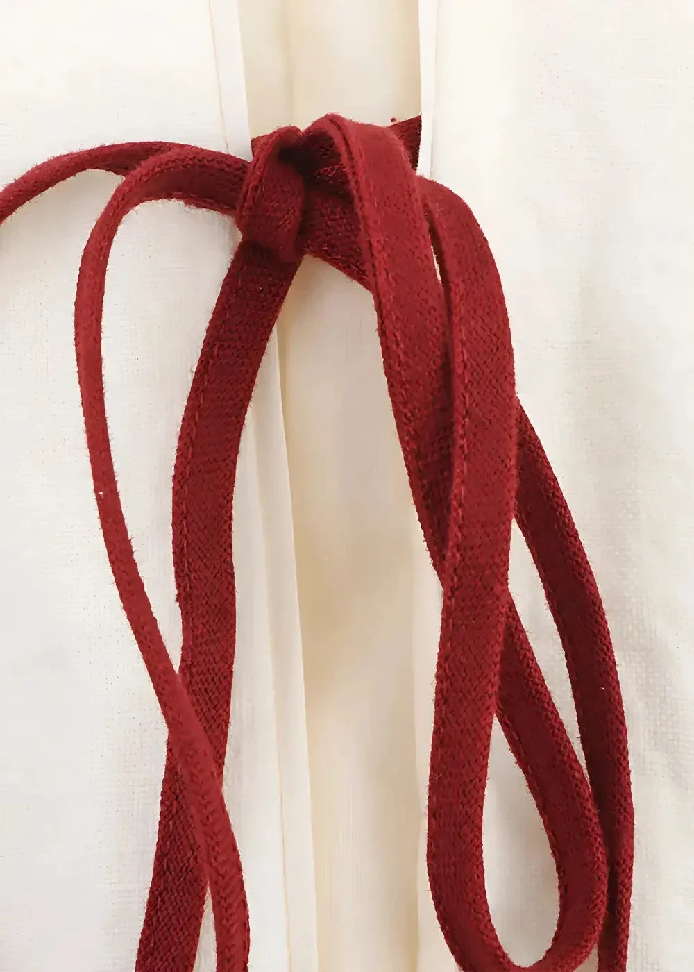 Close-up of the red cord ties on the white embroidered kimono