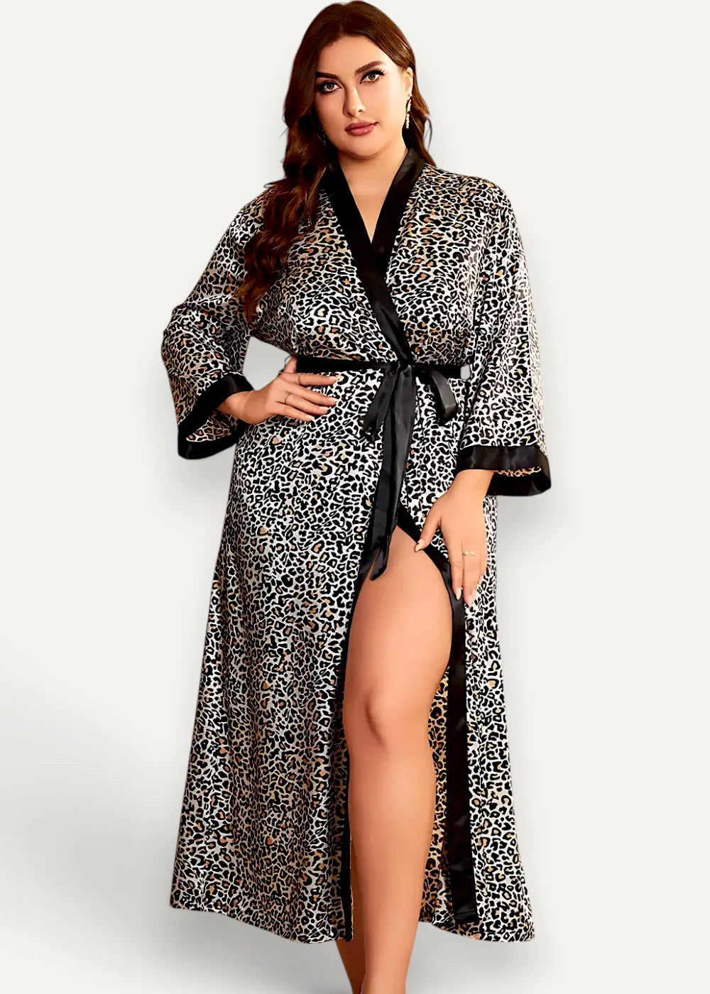 A plus-size woman wears a floor length kimono robe in leopard print with black satin trim and belt