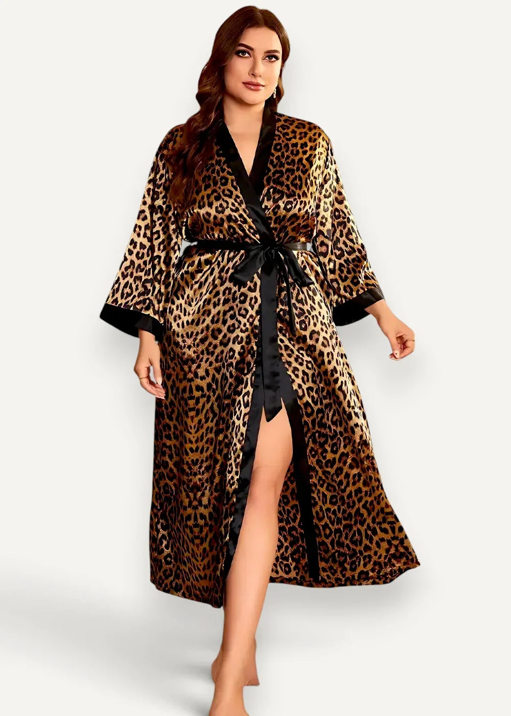 A woman wears a floor length kimono robe with leopard print and black satin trim and belt