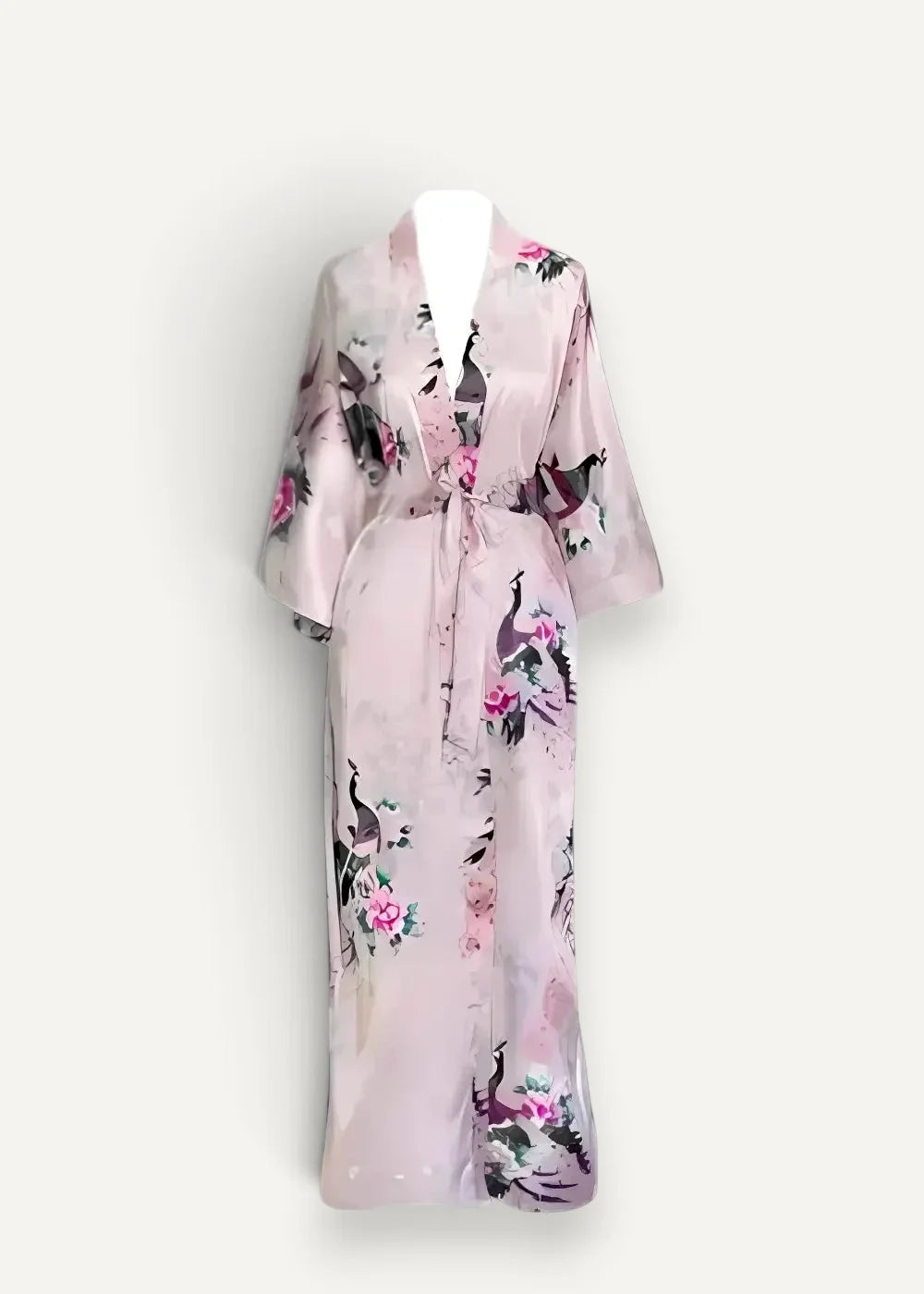 A soft pink floor length silk robe with a delicate peacock floral pattern and belted waist in satin material
