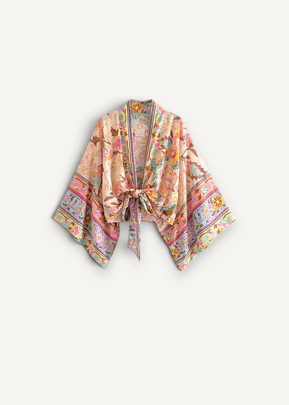A soft peach floral beach kimono top with intricate pastel paisley patterns and a tied front closure
