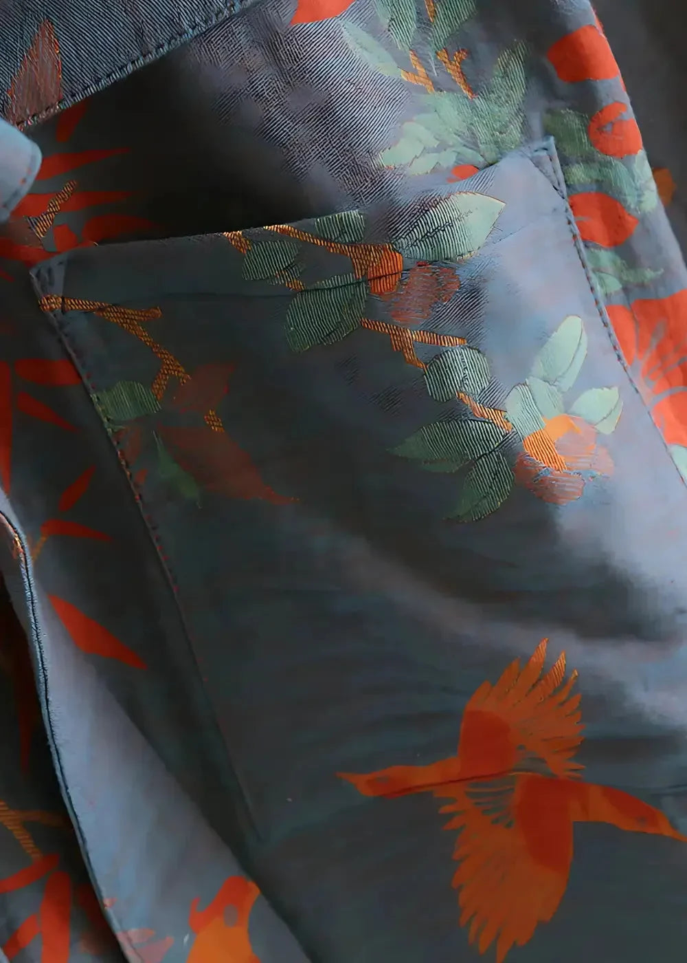 Dark gray cotton kimono robe with vibrant orange green and red floral and bird pattern on denim fabric