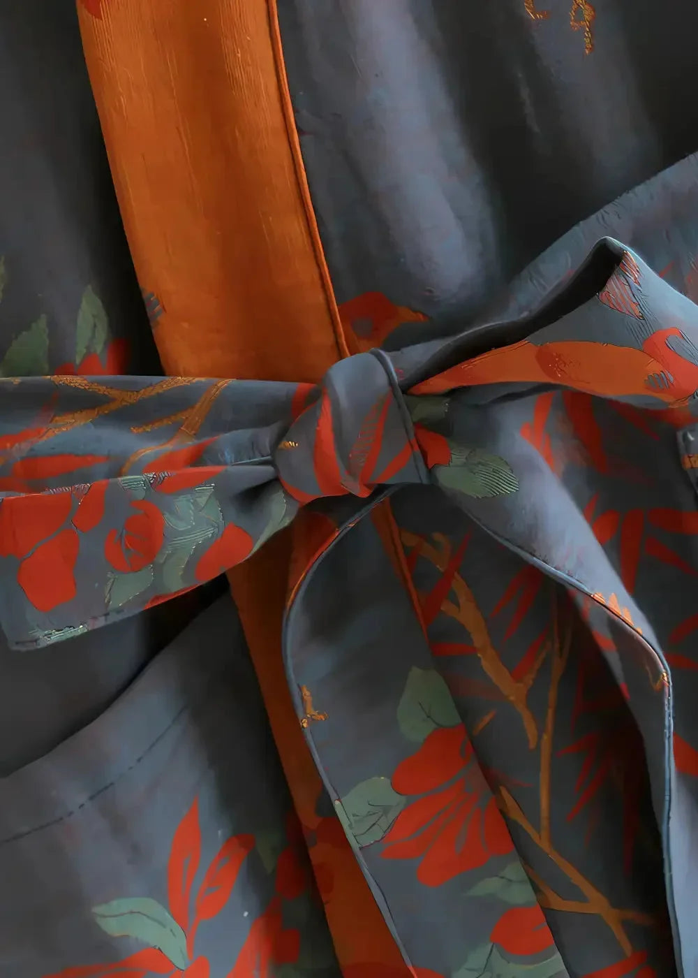 Navy blue cotton floral cotton kimono robe with vibrant orange and green pattern tied at the waist by fabric belt