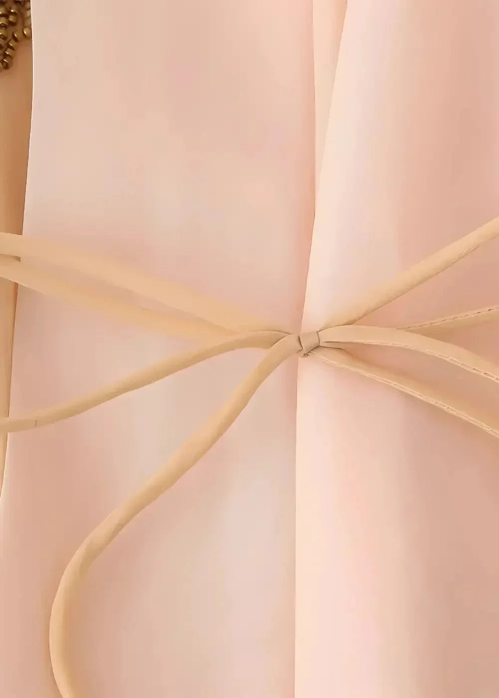 Beige leather belt with delicate knot detail complementing the floral embroidered kimono jacket