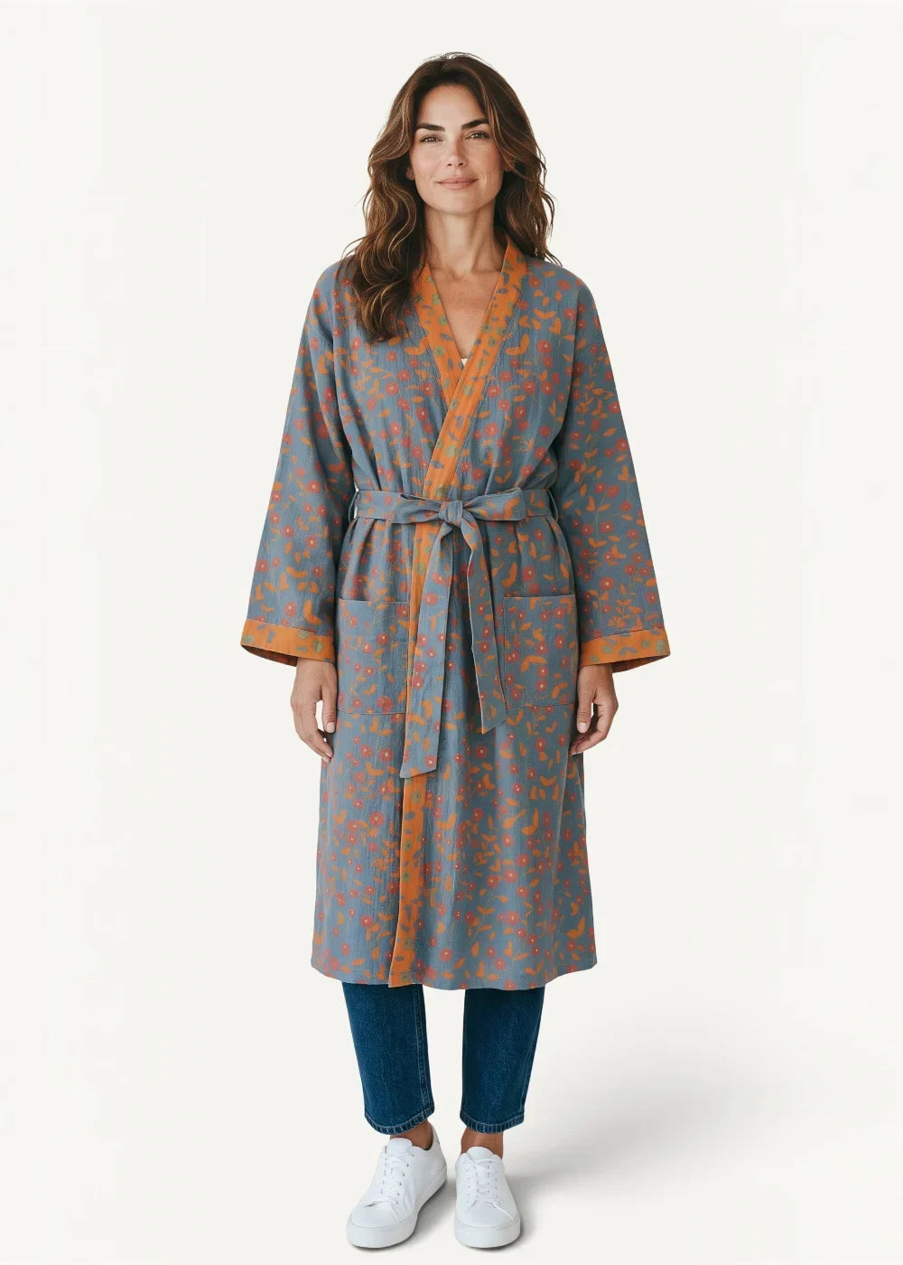 Floral kimono bathrobe in soft blue with delicate floral pattern and warm orange trim on collar cuffs and belt