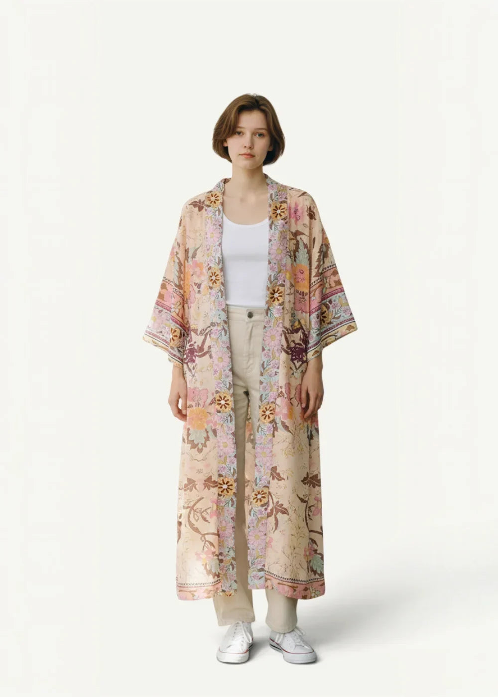 A flowing long-sleeved floral kimono cardigan in soft pastel tones with delicate botanical print