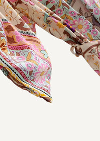 A soft floral kimono cardigan with a flowing pink brown and cream scarf featuring paisley accents along edges